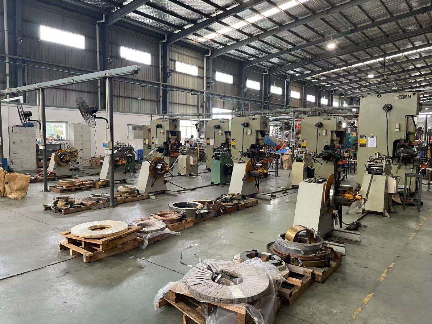 Progressive stamping presses with coil feeders